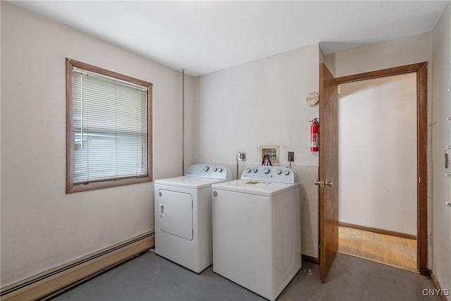 washroom featuring separate washer and dryer, laundry area, and baseboard heating
