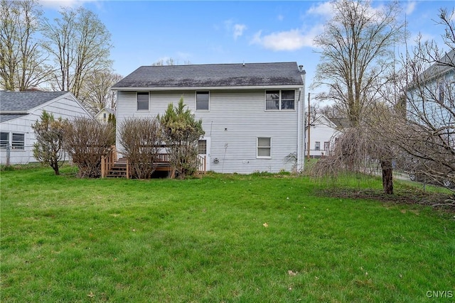 back of house with a lawn and a deck