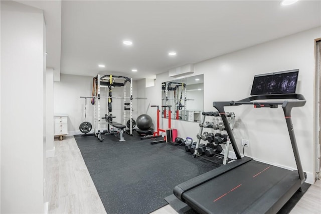 workout room with recessed lighting and wood finished floors