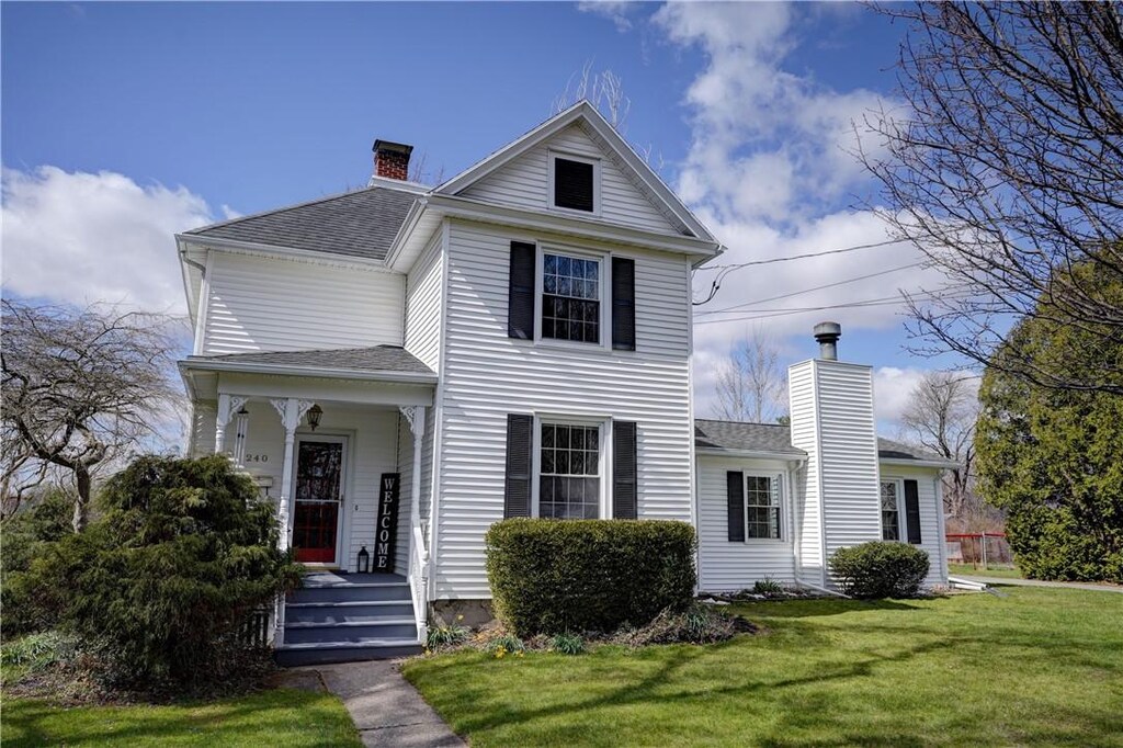 240 N Pleasant St, Canandaigua City, NY 14424 - victorian home featuring a chimney, covered porch, a shingled roof, and a front yard