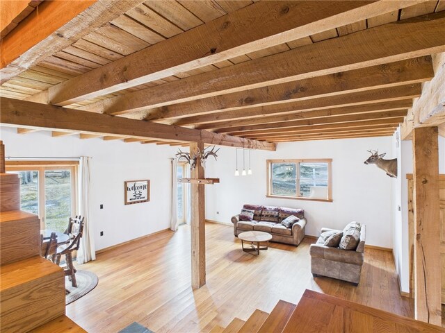 651 Dennis Hill Rd, Harrison, PA 16948 - living room featuring beam ceiling, light wood-style floors, and baseboards