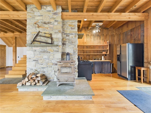 651 Dennis Hill Rd, Harrison, PA 16948 - unfurnished living room featuring wood ceiling, a wood stove, beamed ceiling, wooden walls, and wood finished floors