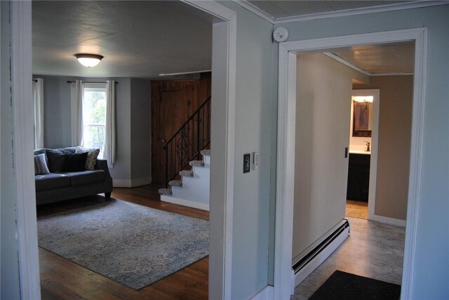 230 Birch St, Kane-Borough, PA 16735 - hallway featuring a baseboard heating unit, stairs, wood finished floors, baseboards, and crown molding
