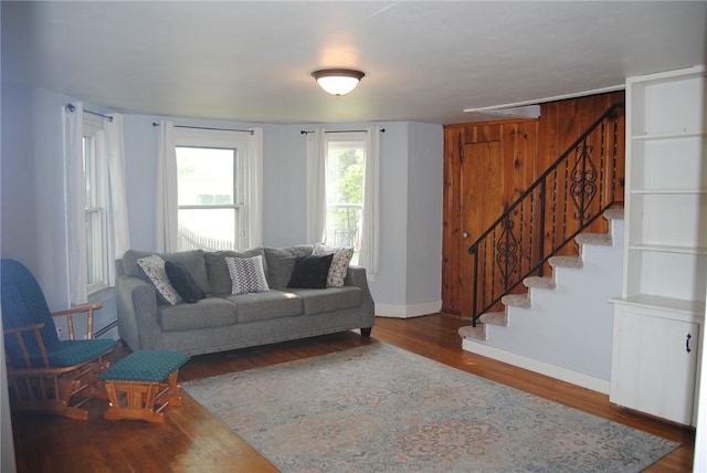 230 Birch St, Kane-Borough, PA 16735 - living area featuring wood finished floors, baseboards, stairway, and baseboard heating