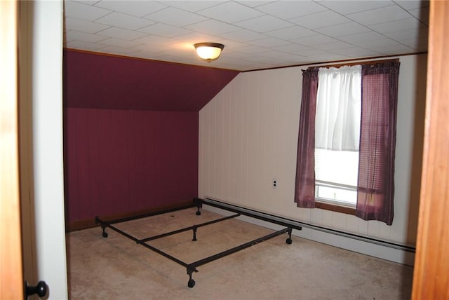 230 Birch St, Kane-Borough, PA 16735 - unfurnished bedroom featuring carpet, multiple windows, a baseboard radiator, vaulted ceiling, and wooden walls
