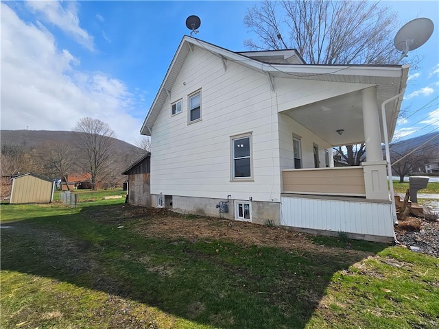 view of side of property with a yard