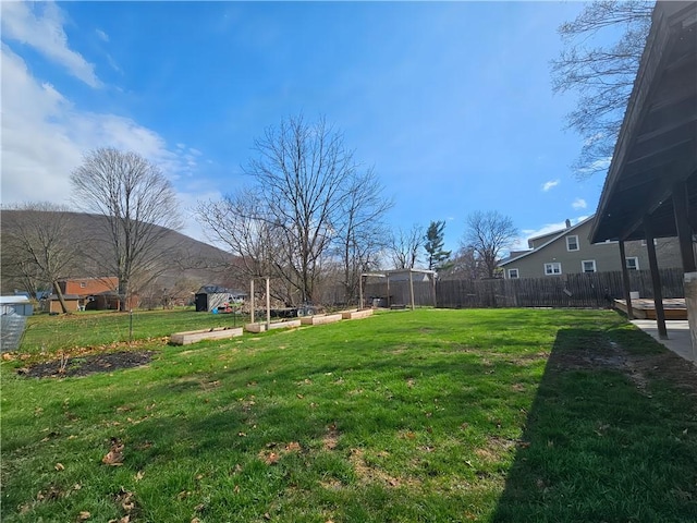 view of yard with fence and a vegetable garden