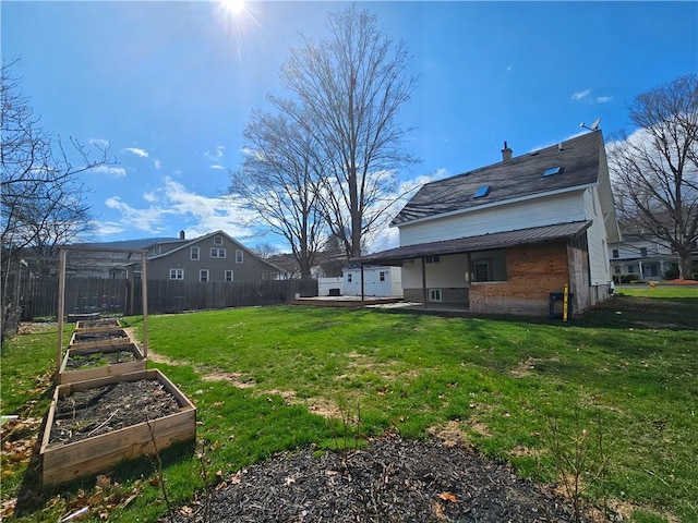 view of yard with a patio area, a vegetable garden, and fence
