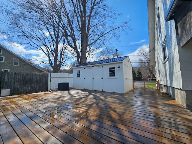 wooden deck with fence, an outbuilding, and central air condition unit