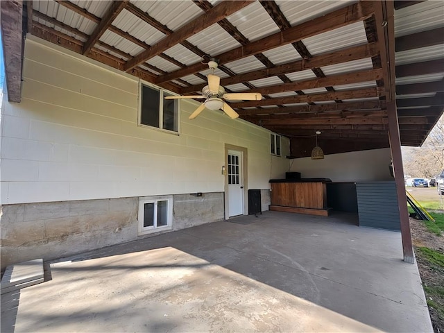 view of patio with a ceiling fan and an exterior structure