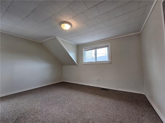 bonus room with baseboards, vaulted ceiling, visible vents, and carpet
