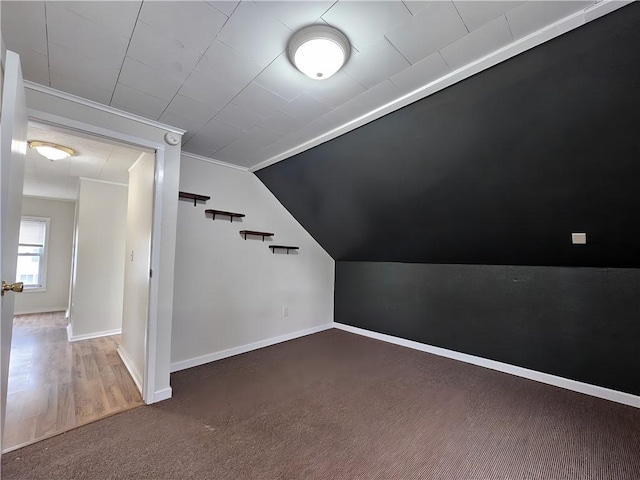 bonus room with lofted ceiling, baseboards, and carpet