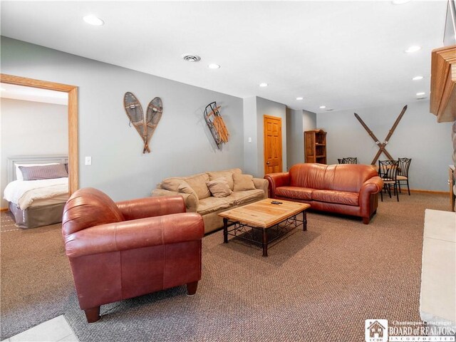 living room with carpet flooring, visible vents, and recessed lighting