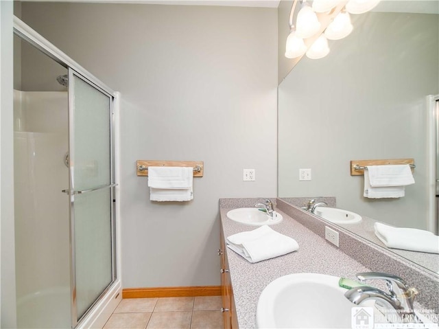 bathroom featuring a shower stall, tile patterned floors, and a sink