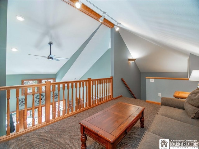 living room featuring vaulted ceiling, carpet flooring, baseboards, and a ceiling fan