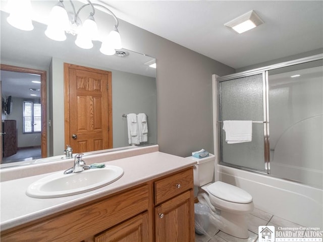 bathroom featuring tile patterned floors, combined bath / shower with glass door, visible vents, vanity, and toilet