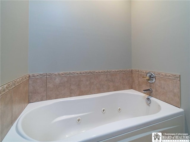 bathroom featuring a tub with jets