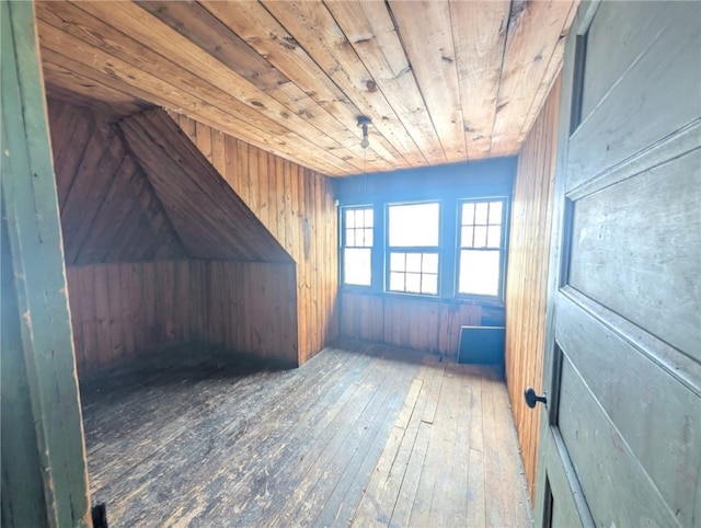 bonus room with wooden walls, hardwood / wood-style floors, and wood ceiling