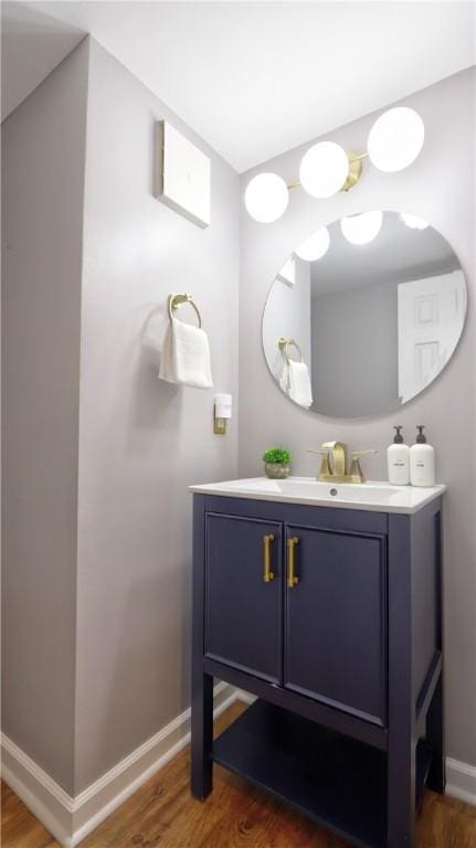 bathroom featuring baseboards, vanity, and wood finished floors
