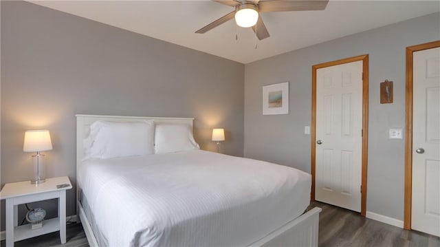 bedroom featuring ceiling fan, baseboards, and dark wood-style floors