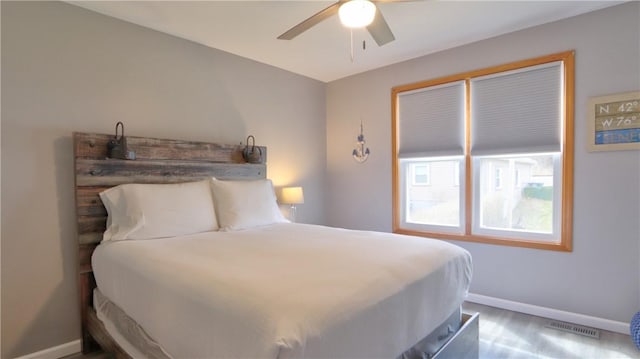 bedroom with visible vents, baseboards, and ceiling fan