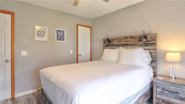 bedroom featuring wood finished floors, baseboards, and ceiling fan