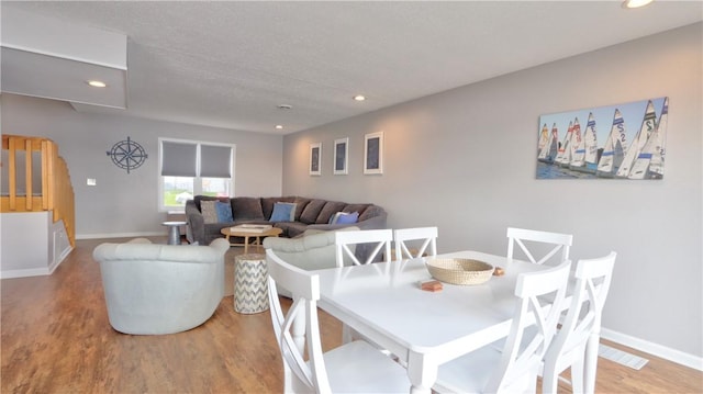 dining room featuring recessed lighting, wood finished floors, and baseboards