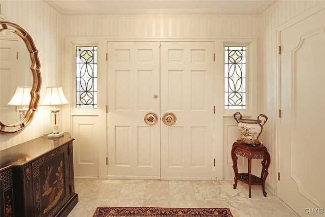 foyer entrance featuring crown molding