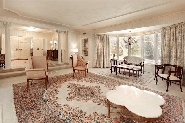 interior space with decorative columns, a chandelier, and ornamental molding