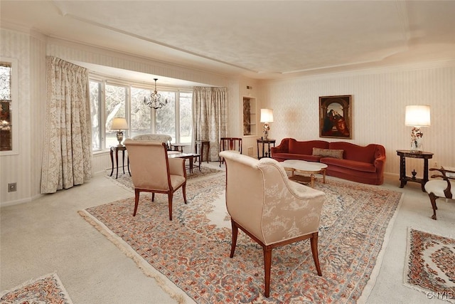living area featuring light colored carpet, an inviting chandelier, crown molding, and baseboards