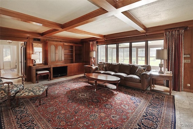 living room with wood walls, beam ceiling, built in features, and coffered ceiling