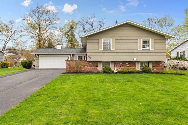 split level home with a garage, driveway, a chimney, and a front yard