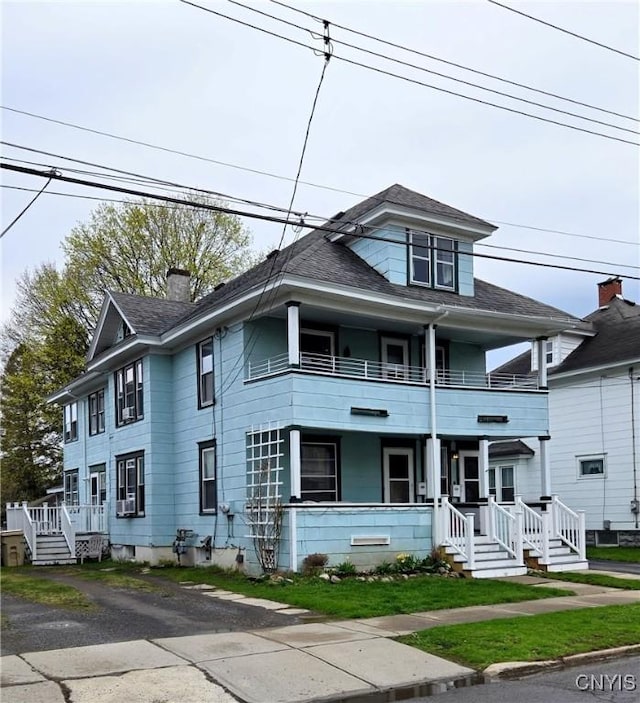view of front of house featuring a chimney, a porch, and a balcony