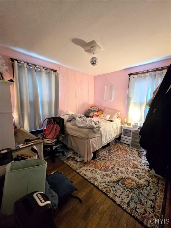 bedroom with wood-type flooring