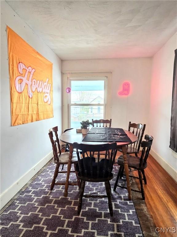 dining area with wood finished floors and baseboards