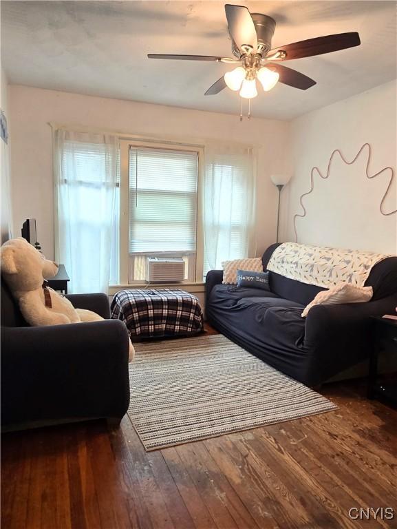 living room with hardwood / wood-style floors, cooling unit, and ceiling fan