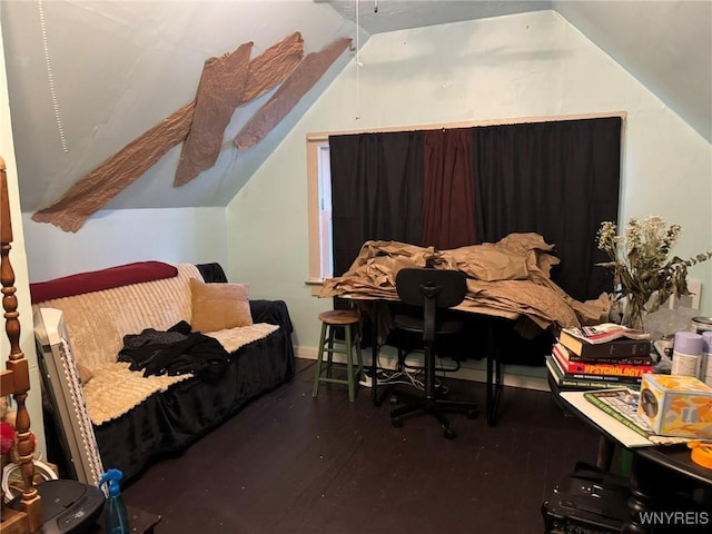 bedroom featuring lofted ceiling and wood finished floors