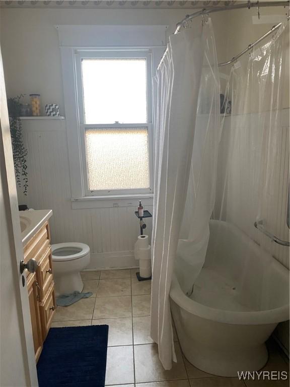 435 Tacoma Ave, Buffalo, NY 14216 - bathroom featuring plenty of natural light, tile patterned floors, vanity, and shower / bathtub combination with curtain
