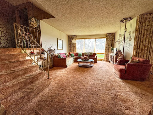 living room featuring carpet flooring, a textured ceiling, and stairway