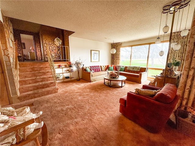 carpeted living area with a textured ceiling and stairs