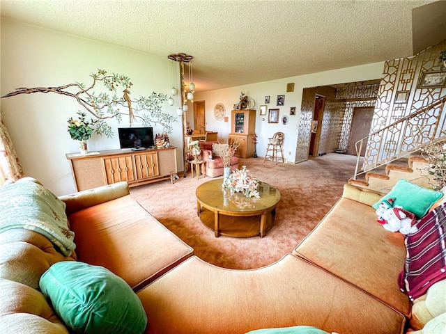 carpeted living room featuring stairway and a textured ceiling