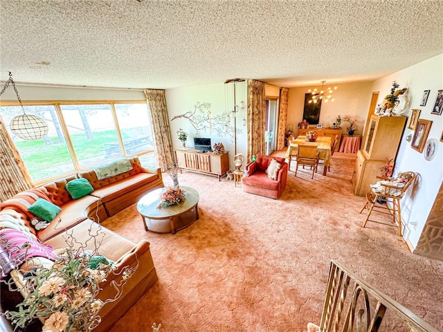 carpeted living room featuring a chandelier and a textured ceiling
