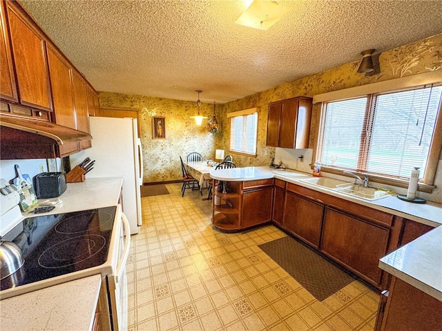 kitchen featuring a textured ceiling, wallpapered walls, brown cabinets, light floors, and range with electric stovetop