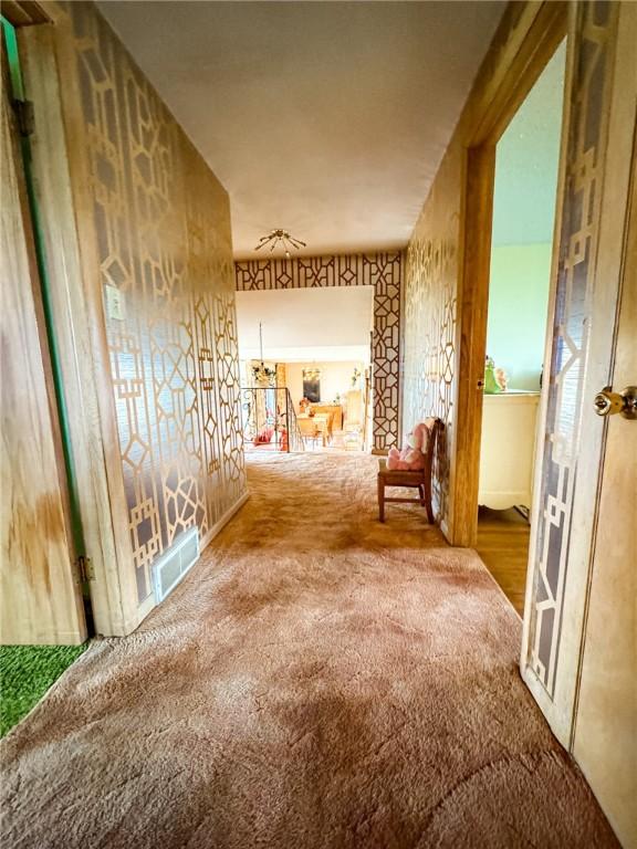 corridor with carpet flooring and visible vents