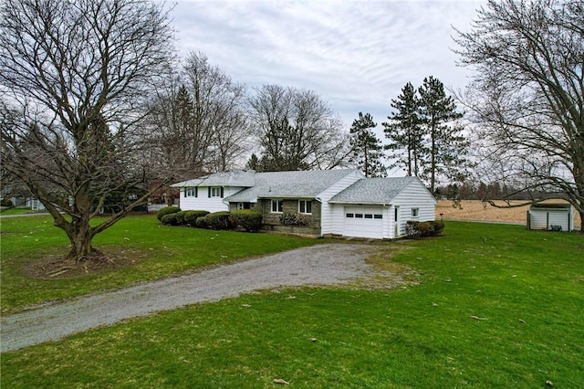 split level home with dirt driveway, a front lawn, and a garage
