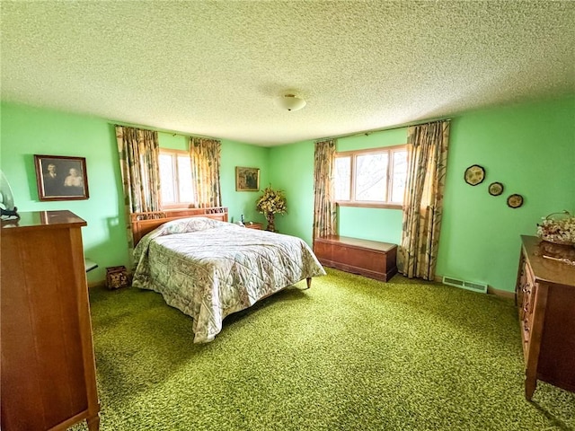 bedroom with visible vents, carpet floors, and multiple windows