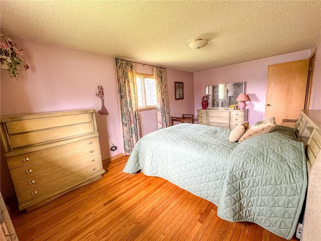 bedroom featuring wood-type flooring and a textured ceiling