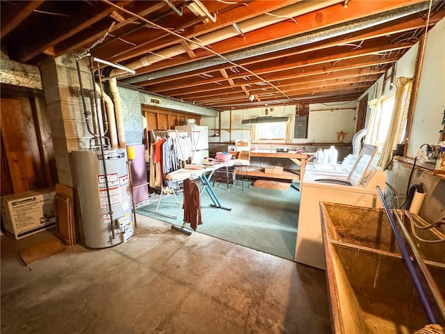 basement with water heater, electric panel, and washer and dryer