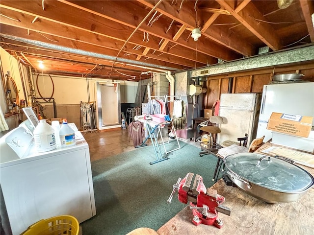 unfinished below grade area with freestanding refrigerator and washer and dryer