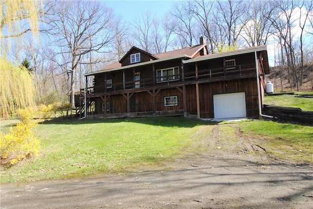 9221 Health St, North Dansville, NY 14437 - log home with an attached garage, dirt driveway, a front yard, and a chimney
